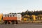 Old white orange construction trailers on a background of autumn forest