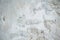 Old white painted limewashed plaster wall texture or background. Close-up