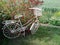 Old white painted metal bicycle .