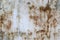 An old, white-painted sheet of metal, damaged by corrosion with spots of blue paint. Background for your design