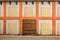 Old White Wall With Checkered Pattern Detail and wooden doorway