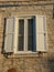 Old white window with shutters