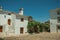 Old whitewashed houses in front of cobblestone square