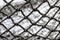 Old wicker net. Mesh net texture looks like cobweb. Grungy graphic style backdrop