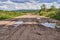 Old wide sandy road with a rolled track after the rain