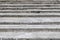 Old, wide and weathered gray concrete stairs structure. Stairway composition, texture, background.