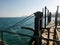 Old winch hoisting mechanism on the sea concrete landing stage