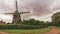 Old wind mill at the dramatic cloudy sky in Holland