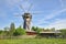 The Old Windmill Behind a Fence in Spring