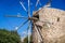 An old windmill on a blue sky background