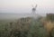 Old windmill in foggy countryside landscape in England