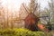 Old windmill in the forest. The sun`s rays make their way through the branches.