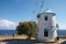 Old windmill on Greece island on the sea beach