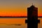 Old windmill in harbor of orbetello