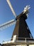 Old windmill in Kent - Black with white sails