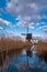 An old windmill known as Broekmolen at the edge of the river in autumn. Technology used to drain marshy land