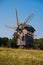 Old windmill in the middle of the picturesque fields