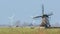 Old windmill with modern windmills in the background