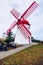 Old windmill Red Peak Mill in Bretanha (Sao Miguel, Azores). Traditional white wind mill with red roof and wings in village