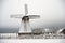 An old windmill. Snowy road, big snowdrifts. January, Estonia, Saaremaa