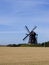 Old windmill in wheat field