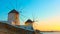 Old windmillls in Mykonos island at sunset