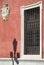 Old window and antique shield in a red facade. Seville, Spain