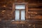 The old window of old wooden house. Background of wooden walls