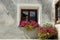 Old window with purple petunia flowers - Zuoz village Switzerland