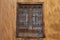 Old window with rusty metal bars in one of the buildings in medina of Meknes, Morocco