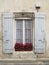 Old window with shutters in Provence style. White curtains