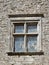 Old window in stone work wall leaded glass