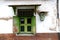 Old windows and an electric meter on a wall in kotagede