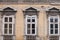 Old windows on the residential building of the urban area of Belgrade Serbia, with a damaged and decaying facade