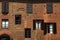 Old windows with shutters on medieval red brick textured wall, I