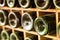 Old wine bottles stacked on wooden racks