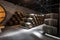 Old wine cellar with big and small wooden barrels for traditional winemaking