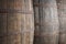 Old wine wooden barrels detail in a winery. Warm tone