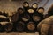 Old winery with wooden barrels full of port wine inside. Dark cellar for winemaking, Portugal