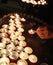 old woman and candles in the place of worship