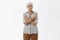 Old woman cannot decide which way better. Portrait of confused unsure granny with grey hair in casual shirt crossing