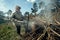 Old woman cleans and burns branches on her farm.