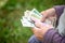 The old woman considers banknotes - hands and money close up