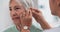 Old woman, doctor hands and patient with hearing aid, help and support with healthcare in clinic. Person with disability