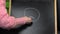 Old woman drawing unhappy smiley on blackboard