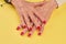 Old woman hands with red manicure.