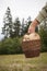 Old woman holding a basket of parasol mushrooms