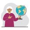 A old woman holds a globe in his hand and points his finger at it. The concept of education, teacher, world conquest