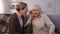 Old woman listening for her senior friend, problems with hearing, deafness
