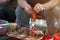 Old woman preparing red peppers for winter pepper sauce, ajvar